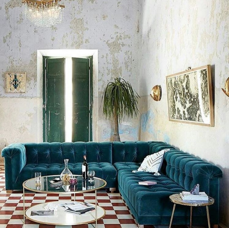 #9 | Jewel tones & velvet fabric are IN and this couch proves why. Paired with the red checked tile floor, distressed walls and art decor light fixtures: perfection. Milray Tip: merge design styles for unique and delightful results! We'd say this was a combo of Hollywood Regency meets Cuba meets Diner Decor. Via @ettoresottsass